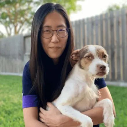 Dr. Lee holding her dog outside